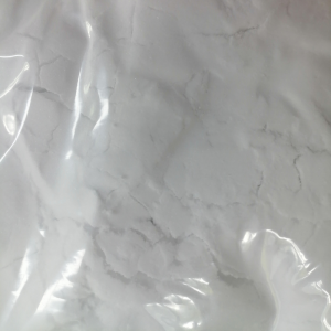 Macro photography revealing the fine, uniform, white powder texture of Huachem Ectoin.