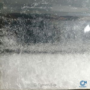 Macro photography revealing the fine, uniform, white powder texture of Huachem O-Cymen-5-Ol.