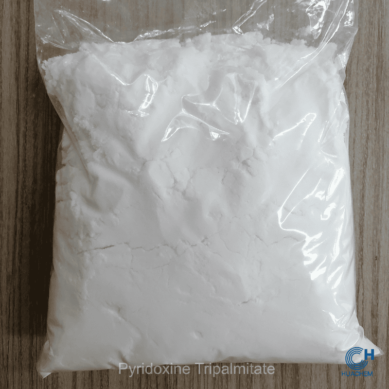 Huachem Pyridoxine Tripalmitate white powder visibly sealed inside a transparent inner polyethylene bag.