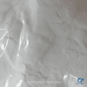 Macro photography revealing the fine, uniform, white powder texture of Huachem Pyridoxine Tripalmitate.